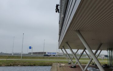 2 Abseiltechnieken monteren lichtreclame boven water rope access advertising (Middel)